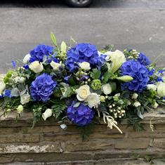 Blue and white casket spray 